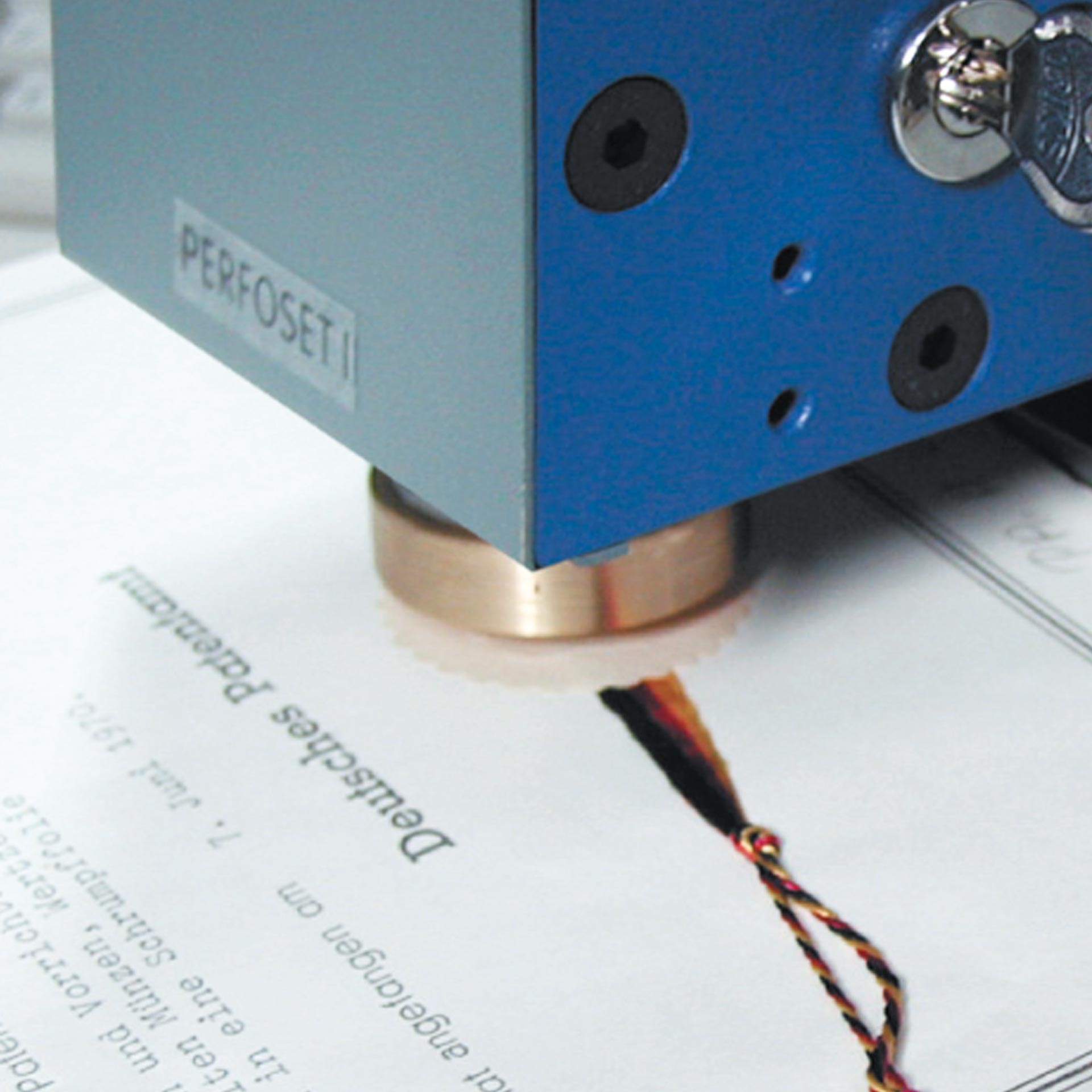 PERNUMA PERFOSET I/P & II/P Detailansicht Prägeeinheit Detailansicht der Prägeeinheit des PERNUMA PERFOSET I/P & II/P beim Prägen eines Dokuments mit Kordel und Siegelstelle.